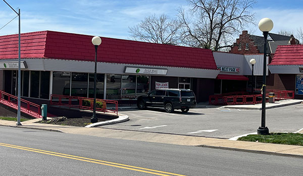 photo of 1 front of building with red roof.